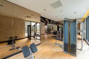 a gym with chairs and mirrors in a building at Căn Hộ 2 Phòng ngủ LUXURY-1516 in Gia Lâm Pho