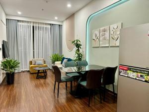 a living room with a table and chairs and a couch at Căn Hộ 2 Phòng ngủ LUXURY-1516 in Gia Lâm Pho +11 photos