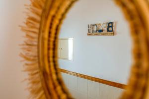 a mirror reflection of a bathroom with a wall at TAC - Serenity Manta Rota in Vila Nova De Cacela