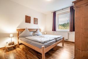 a bedroom with a bed and a window at Kolbatzer Mühle in Lychen