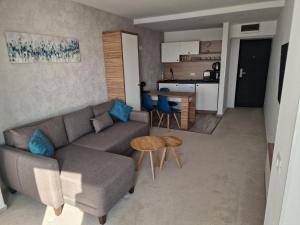 a living room with a couch and a table and a kitchen at Apartamente Topaz Sea View Olimp in Olimp