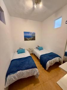 a bedroom with two beds in a room at Casa Chana y Domingo in Agulo