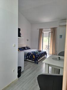 a bedroom with a bed and a table in it at Apartment Mate in Bibinje