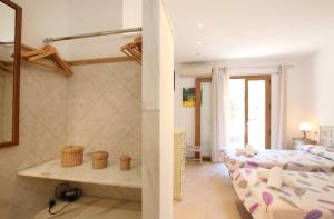 a bedroom with two beds and a living room at Ca Na Barbara in Santanyi +12 photos