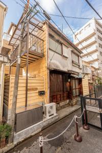 a wooden house with a fire hydrant on a street at skytree Family Hotel in Tokyo