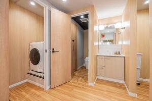 a laundry room with a washer and dryer in it at skytree Family Hotel in Tokyo