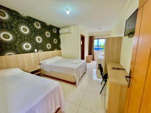 Postel nebo postele na pokoji v ubytování HOTEL GUAIRACÁ