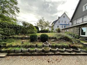 a garden in front of a house with birds in it at Meine HarzZeit in Goslar