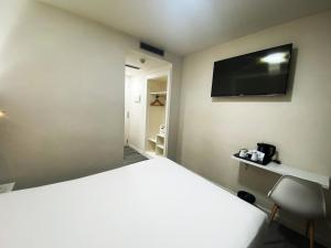 TV a/nebo společenská místnost v ubytování BCN Urbaness Hotels Del Comte