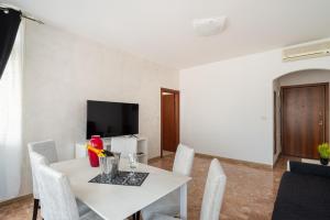 a white dining room with a white table and chairs at Like At Home Venice - Mestre in Mestre
