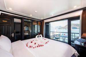 a bedroom with a bed with a swan on it at Dragon Premium Cruise Halong in Ha Long +45 photos