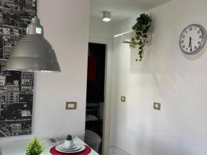 a dining room with a table and a clock on the wall at Aldaba by Huskalia in Los Llanos de Aridane