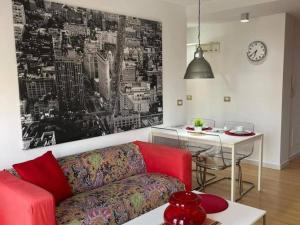 a living room with a red couch and a table at Aldaba by Huskalia in Los Llanos de Aridane