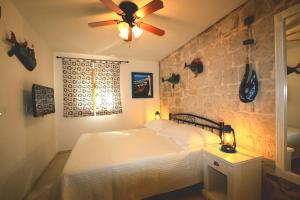 a bedroom with a bed and a ceiling fan at Historic house in Stari Grad