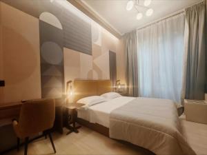 A bed or beds in a room at The B Place