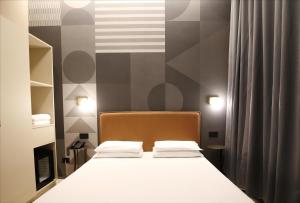 A bed or beds in a room at The B Place