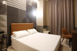 A bed or beds in a room at The B Place