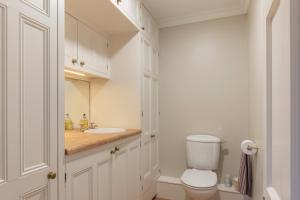 a bathroom with a toilet and a sink at East House in High Legh +15 photos