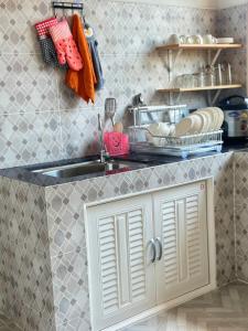 a kitchen with a sink and a counter top at Jenny Garden House in Ban Madua Wan +15 photos