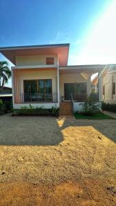 a large house with a driveway in front of it at Jenny Garden House in Ban Madua Wan
