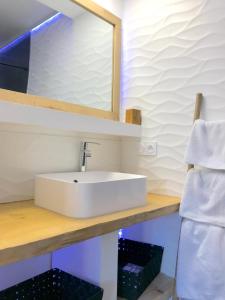 un bagno con un lavandino bianco e uno specchio di Myappartement Perpignan Mediterannée a Perpignano
