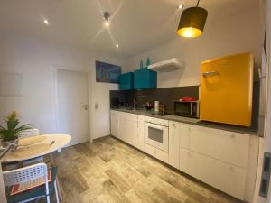 a kitchen with white cabinets and a yellow refrigerator at Triple M in Seligenstadt