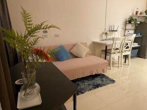 a living room with a couch and a table at Patunam Building , Shopping , Airport Rail link in Bangkok