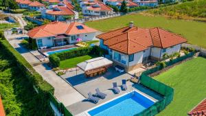an aerial view of a house with a swimming pool at GERANIUM Holliday Villas in Obrochishte