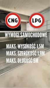 two signs hanging on a wall in a building at Metropolis Old Town Apartments in Krakow +69 photos