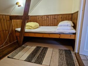 a bunk bed with two pillows on it in a room at Trea centralt Västervik in Västervik