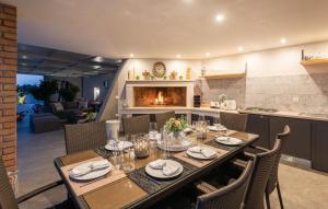 a dining room with a table and a fireplace at Villa St. Anna in Radetići - Haus für 8 Personen in Radetići