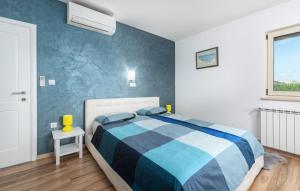 a bedroom with a blue and white bed and a window at Villa St. Anna in Radetići - Haus für 8 Personen in Radetići +36 photos