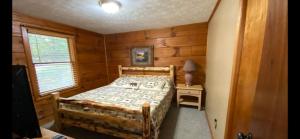 a bedroom with a bed in a wooden room at Mountain Laurel in Sevierville
