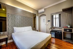 a bedroom with a large white bed and a television at B&B Residenza le Fonticine in Florence