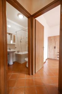 a bathroom with a tub and a toilet and a sink at Casa Marta in Valdisotto