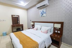 a bedroom with a large bed with pink pillows at قصر الريان in Buraymān +8 photos