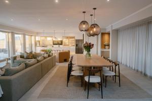 a living room and dining room with a couch and a table at Escape to the Beach in Wilderness