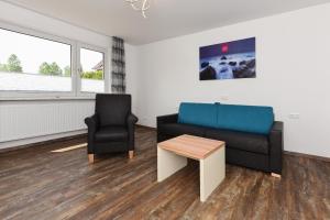 a living room with a couch and a chair at Zur Möwe 5 in Esens