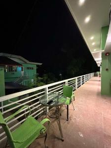 a table and chairs on a balcony at night at ZV Homes in Tagbilaran City