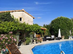 a villa with a swimming pool and a house at La Maison Verger in Limalonges