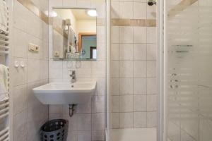a bathroom with a sink and a shower at Pension Ufert in Meißen +21 photos