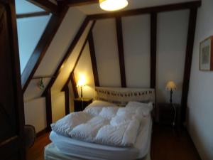 1 dormitorio con 1 cama blanca en el ático en Chalet avec vue panoramique sur le Plomb du Cantal, en Saint-Jacques-des-Blats