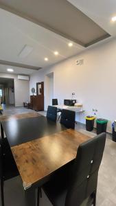 a conference room with a large wooden table and chairs at airport apartments camera orchidea in San Maurizio Canavese