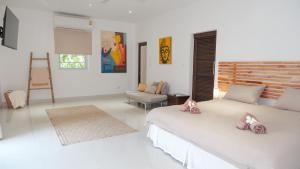 a white bedroom with two beds and a chair at Villa sun in Amphoe Koh Samui +32 photos