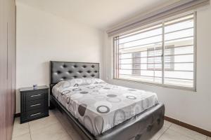 a bedroom with a bed and a window at Taz's house in Hacienda Yacucalle