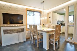 a kitchen and dining room with a table and chairs at Modernes Ferienhaus mit Kamin & Garten in ruhiger Lage in Hasselfelde +19 photos