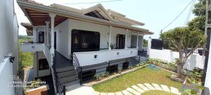 a small white house with a porch at Jacindavilla in Ambalangoda