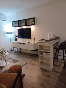 a living room with a white desk with a television at Apartman SONJA in Zadar