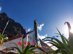 a building with flags on the side of it at Studio Casa Tropicana in Paul do Mar