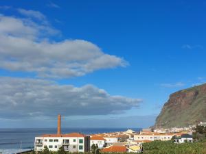 a view of a city with a mountain and the ocean at Studio Casa Tropicana in Paul do Mar +16 photos